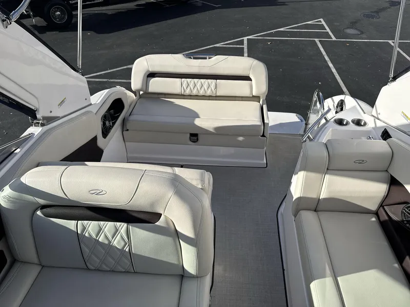Slide: The Image of 2023 Regal 28EX boat interior with luxurious white seating and modern design. - 10