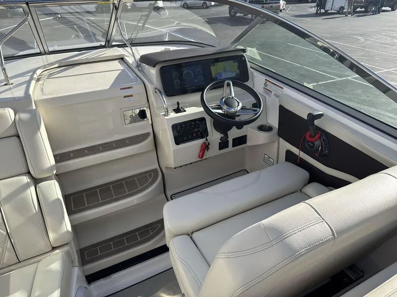 Slide: The Image of 2023 Regal 28EX boat interior with steering wheel and dashboard controls. - 11