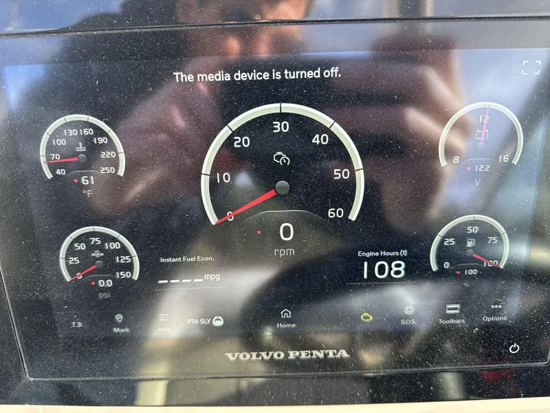 Slide: The Image of Dashboard of 2023 Regal 28EX boat showing gauges and engine hours. - 14