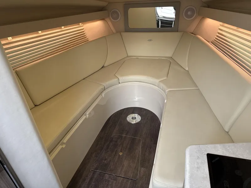Slide: The Image of Luxurious interior of 2023 Regal 28EX boat with beige seating and wood flooring. - 18