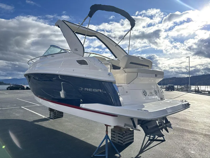 Slide: The Image of 2023 Regal 28EX boat on display under a partly cloudy sky. - 5