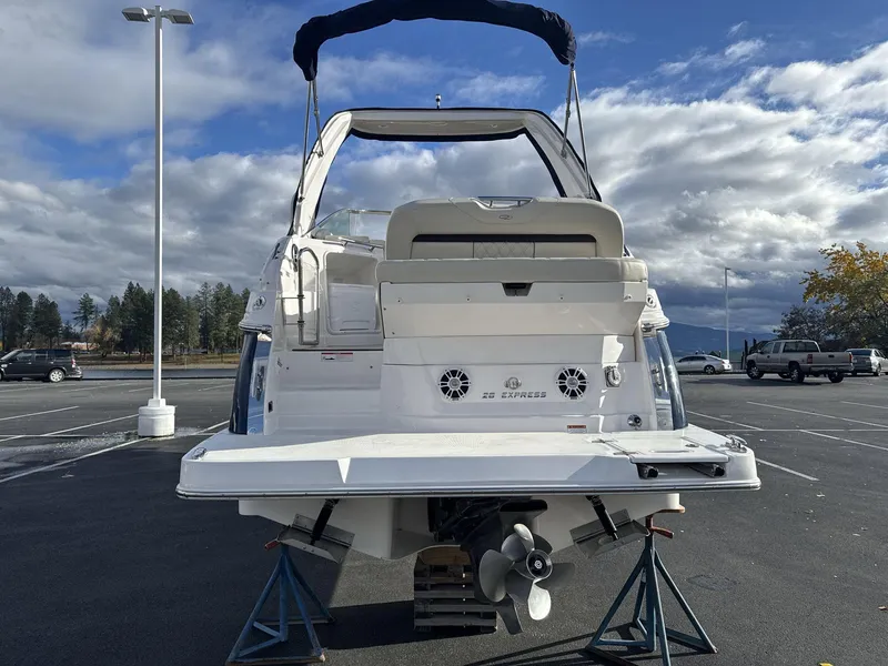 Slide: The Image of 2023 Regal 28EX boat in parking lot, rear view with clear sky background. - 6