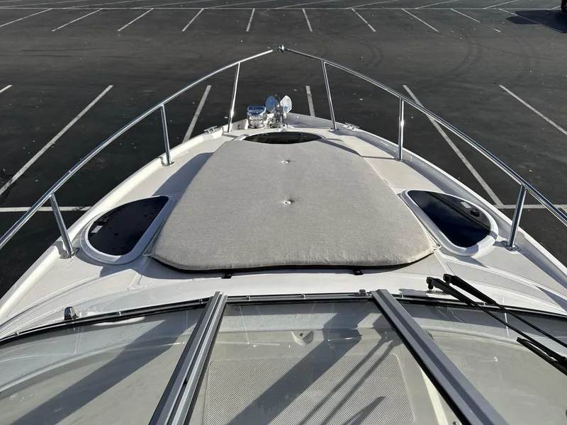 Slide: The Image of 2023 Regal 28EX boat bow view in empty parking lot. - 9