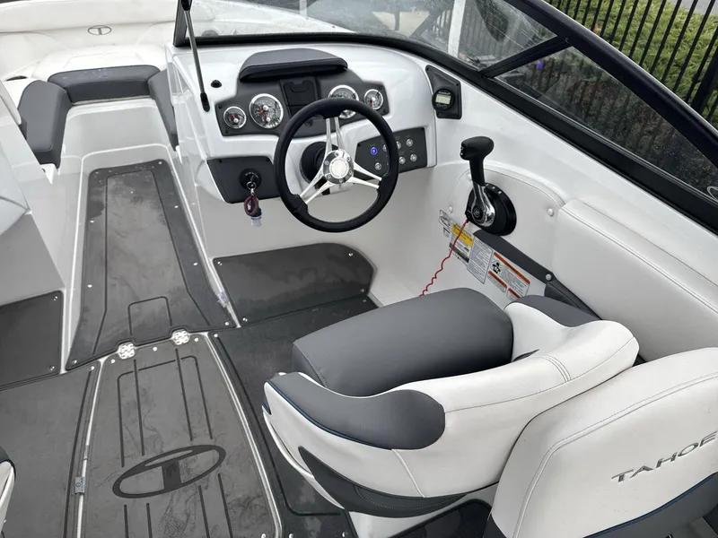 Slide: The Image of 2022 Tahoe 210 S boat interior with steering wheel and dashboard controls. - 10