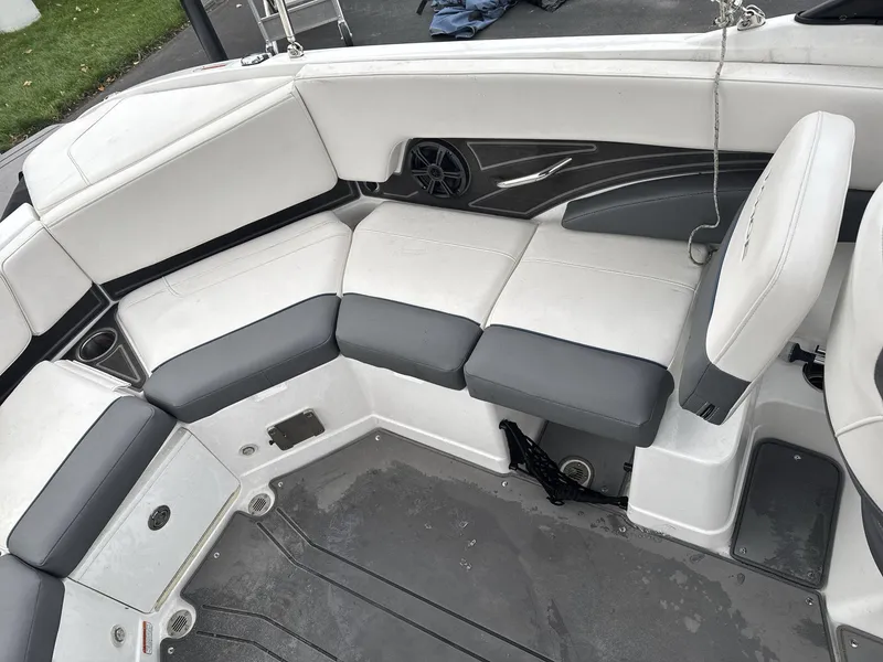 Slide: The Image of 2022 Tahoe 210 S boat interior with gray and white seating. - 13