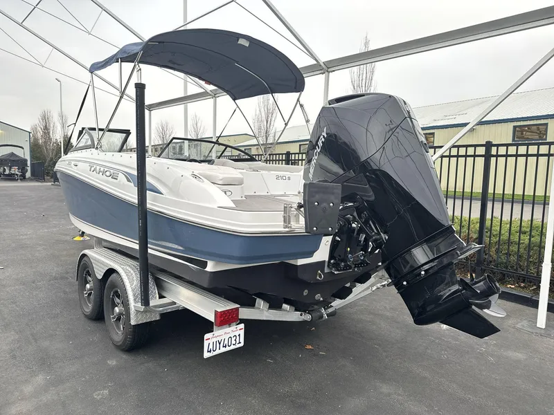 Slide: The Image of 2022 Tahoe 210 S boat on trailer with outboard motor and canopy. - 6