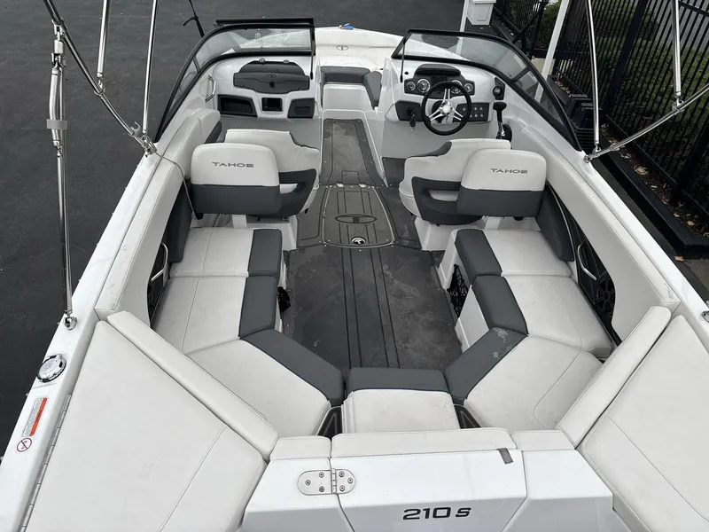 Slide: The Image of 2022 Tahoe 210 S boat interior with spacious seating and modern dashboard. - 7