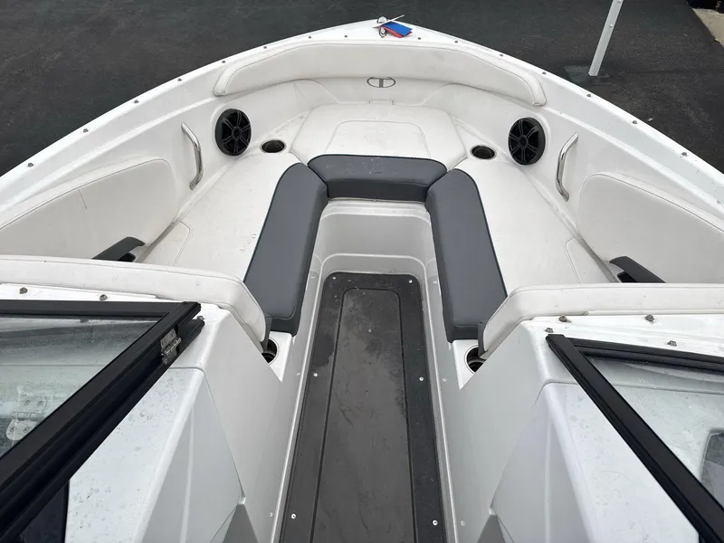 Slide: The Image of 2022 Tahoe 210 S boat interior with gray seating and cup holders. - 8