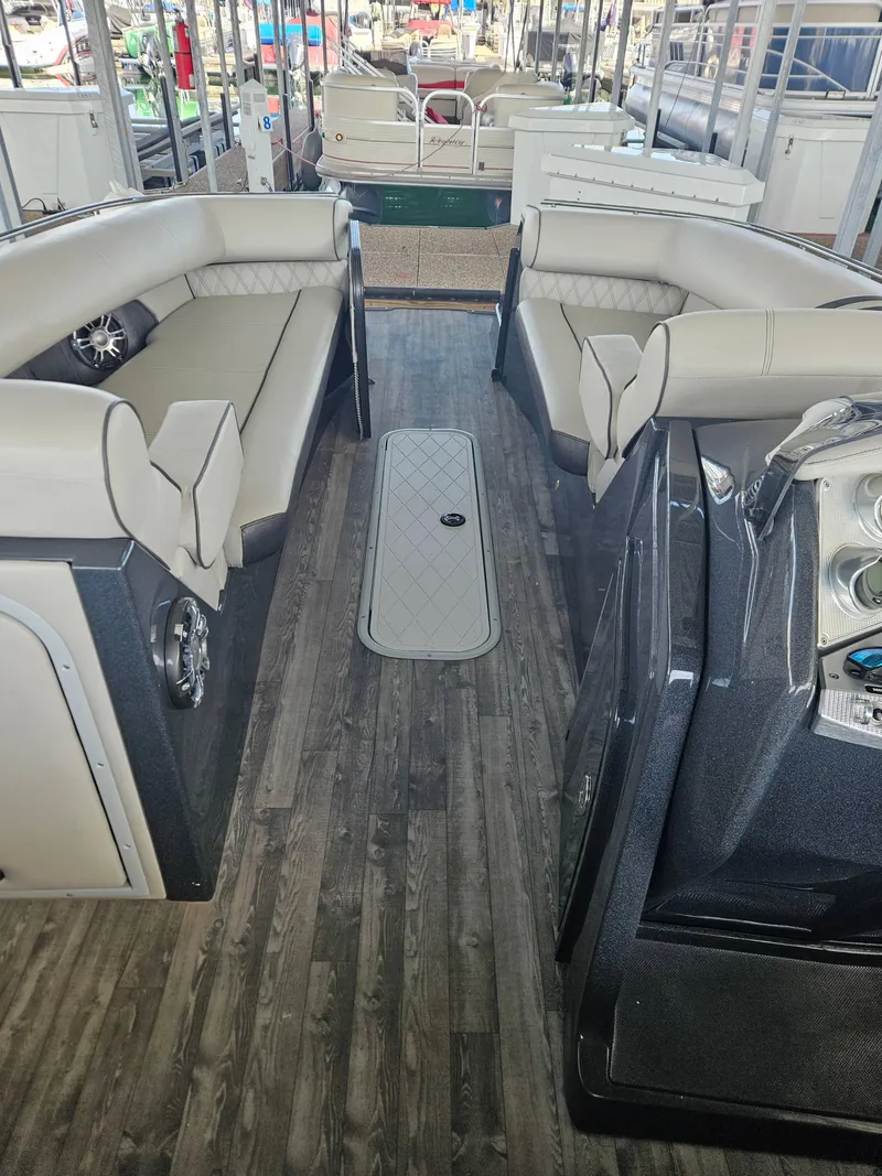 Slide: The Image of 2018 Crest Savanagh boat interior with gray seating and wood flooring. - 6