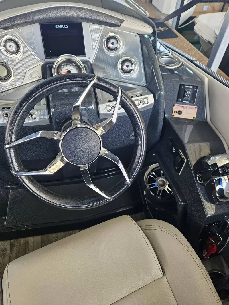Slide: The Image of 2018 Crest Savanagh boat dashboard with steering wheel and control panel. - 8