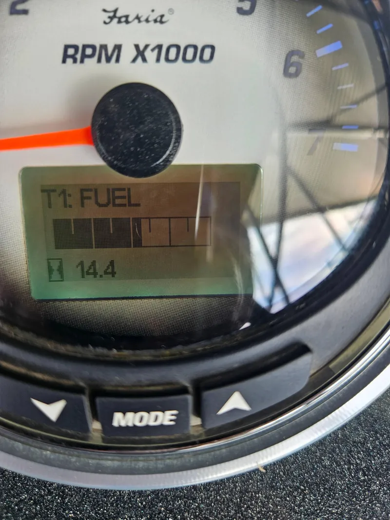 Slide: The Image of Close-up of a Faria RPM gauge displaying fuel level and reading 14.4. - 9