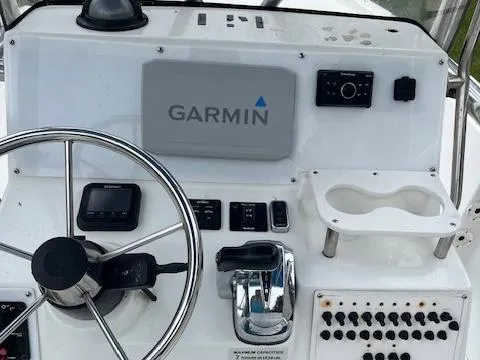 Slide: The Image of 2004 Triton 240 LTS boat console with Garmin navigation system and steering wheel. - 5