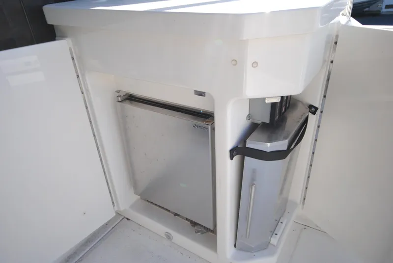 Slide: The Image of 2017 Sea Ray Sundancer 510 yacht kitchenette with compact fridge and trash bin. - 11