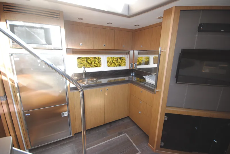 Slide: The Image of Modern kitchen interior of 2017 Sea Ray Sundancer 510 yacht with sleek cabinetry and appliances. - 22