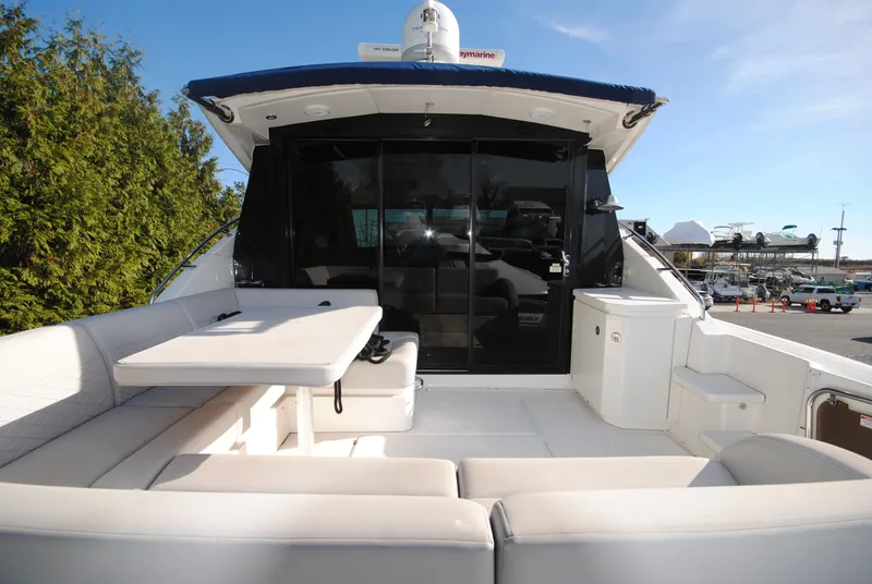 Slide: The Image of 2017 Sea Ray Sundancer 510 yacht with spacious outdoor seating and table. - 9