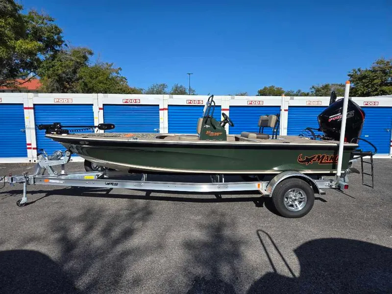 The Image of 2025 Mako 18 Pro Skiff Backwater Edition on trailer, parked near storage units. - 0