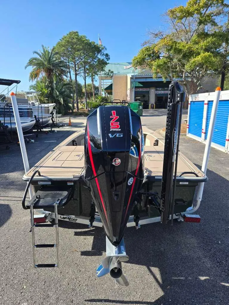 Slide: The Image of 2025 Mako 18 Pro Skiff Backwater Edition with powerful V6 engine, parked outdoors. - 3