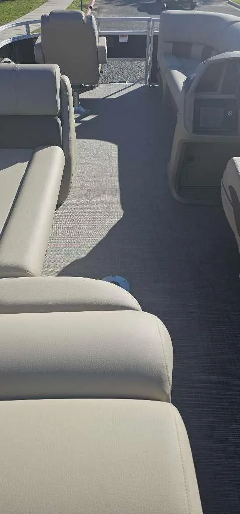 Slide: The Image of 2025 Sun Tracker SportFish 20 DLX pontoon boat interior with beige seating. - 3