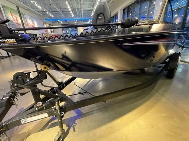 Slide: The Image of 2024 Tracker Targa V-18 Combo boat on display in a showroom. - 2