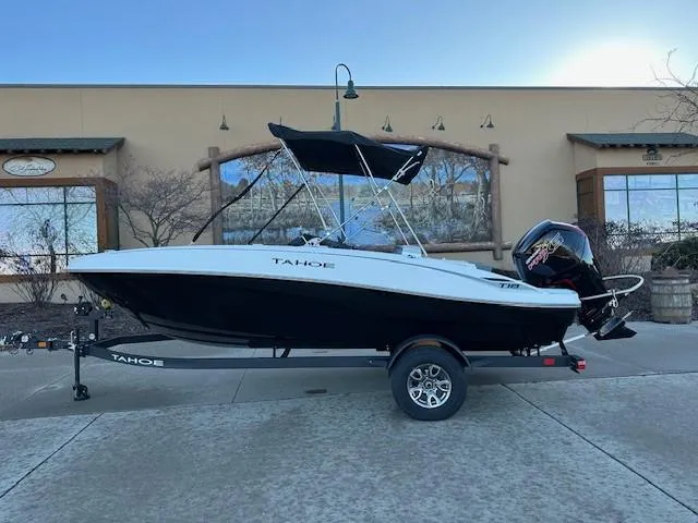 Slide: The Image of 2025 Tahoe T18 boat on trailer, parked outdoors. - 0
