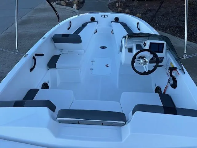 Slide: The Image of 2025 Tahoe T18 boat interior with seating and steering console. - 11