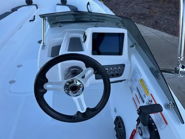 Slide: The Image of 2025 Tahoe T18 boat dashboard with steering wheel and digital display. - 7