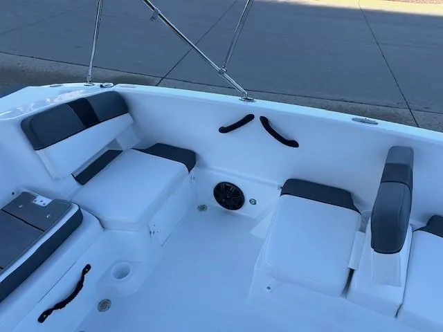 Slide: The Image of 2025 Tahoe T18 boat interior with white and gray seating, cup holders, and speaker. - 8