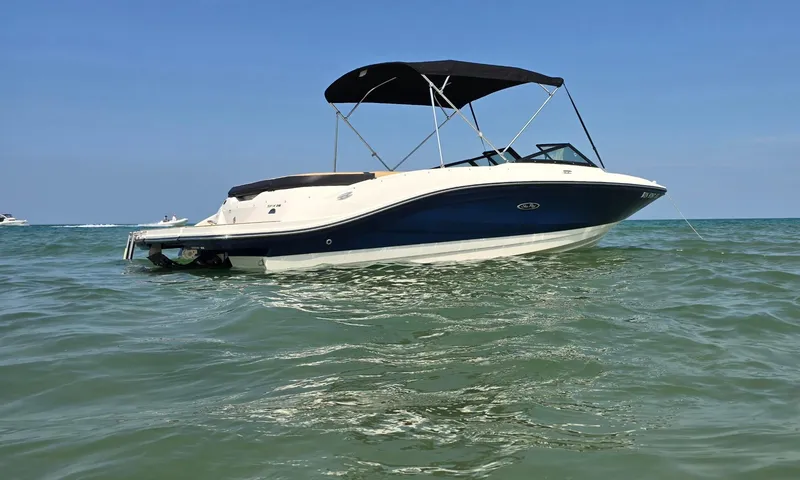 Slide: The Image of 2023 Sea Ray SPX 210 boat on calm ocean waters. - 10