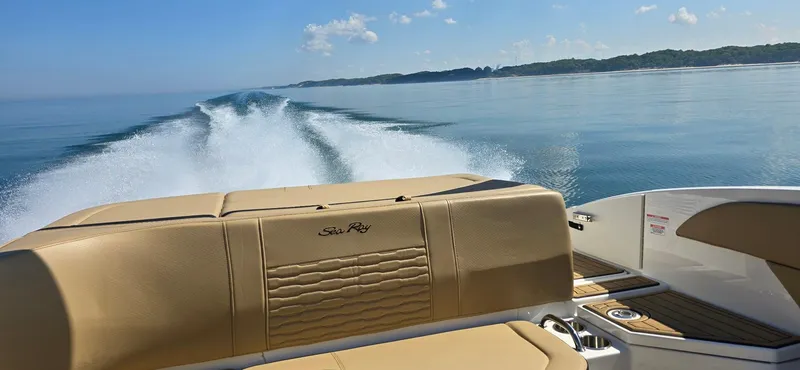 Slide: The Image of 2023 Sea Ray SPX 210 cruising on calm waters, leaving a wake behind. - 7