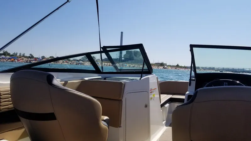 Slide: The Image of 2023 Sea Ray SPX 210 boat interior with ocean view and sunny beach background. - 8