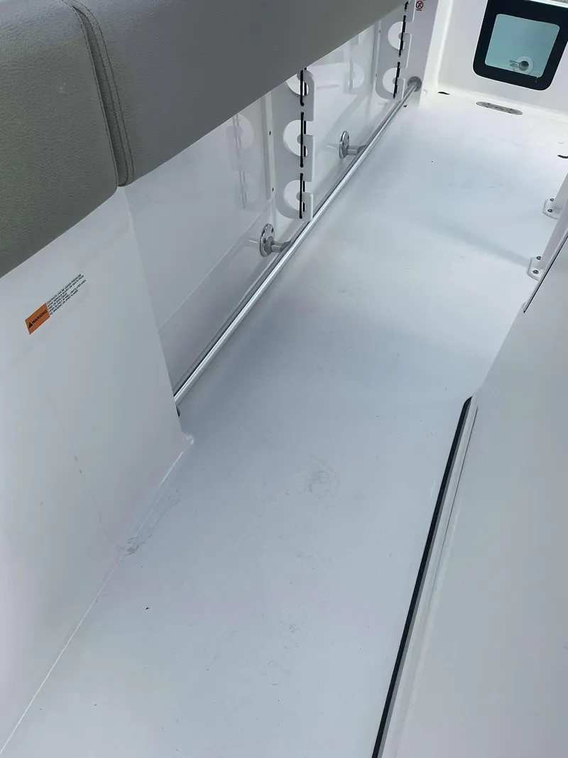 Slide: The Image of 2025 Sportsman 231 Heritage boat interior with rod holders and seating. - 11