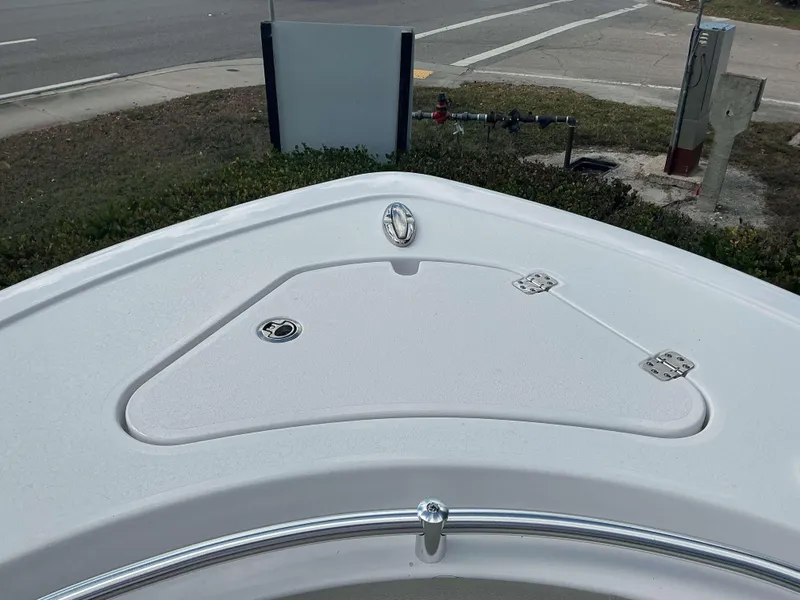 Slide: The Image of Bow of 2025 Sportsman 231 Heritage boat with storage compartment and chrome railing. - 15