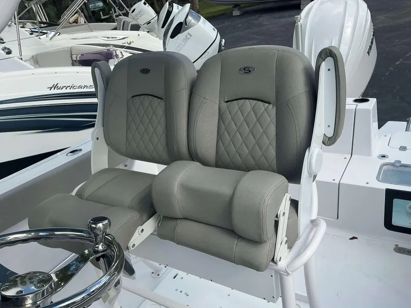 Slide: The Image of 2025 Sportsman 231 Heritage boat seats with diamond stitching and steering wheel. - 5