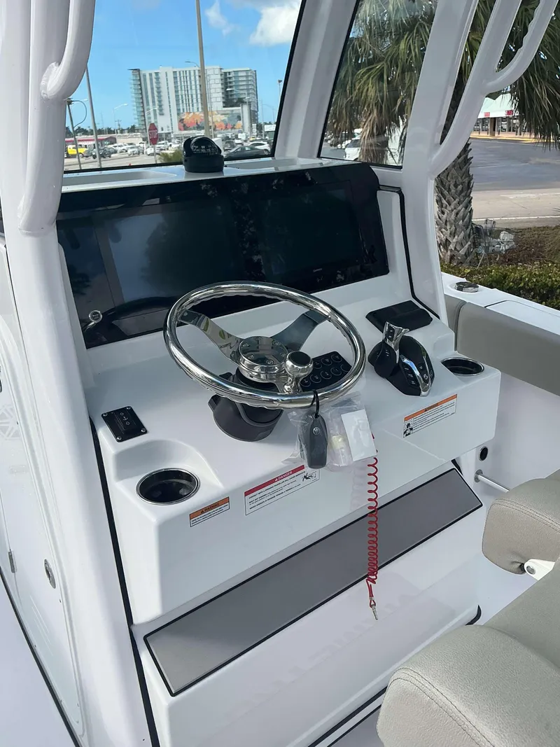 Slide: The Image of 2025 Sportsman 231 Heritage boat console with steering wheel and controls. - 6