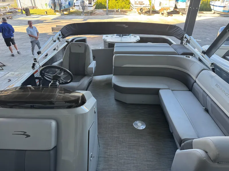 Slide: The Image of 2020 Bennington SX21 pontoon boat interior with gray seating and steering console. - 3