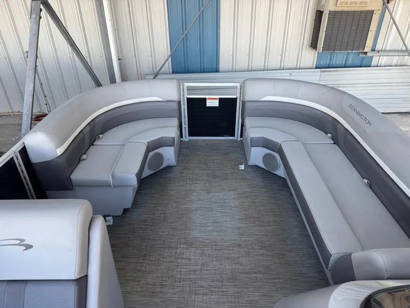Slide: The Image of 2020 Bennington SX21 pontoon boat interior with gray seating and carpeted floor. - 4