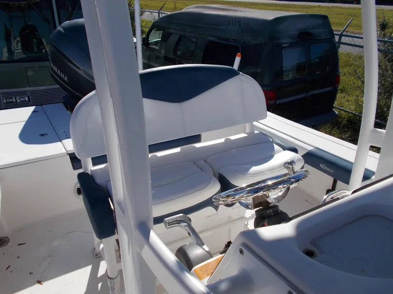 Slide: The Image of 2020 Robalo 246 Cayman boat interior with seating and steering wheel. - 10