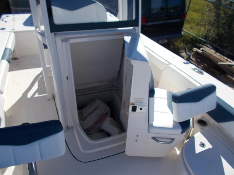 Slide: The Image of 2020 Robalo 246 Cayman boat interior with open storage compartment and seating. - 11
