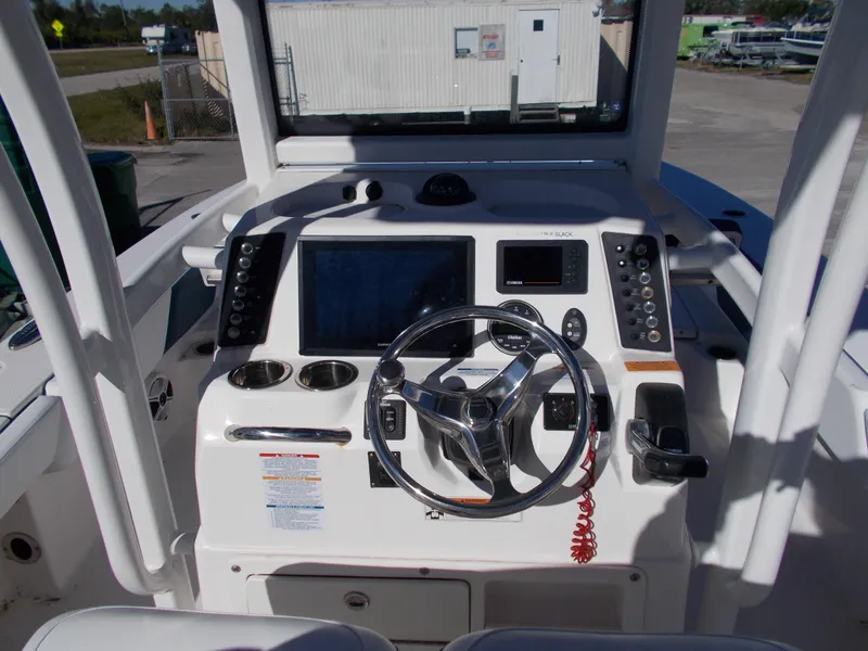 Slide: The Image of 2020 Robalo 246 Cayman boat dashboard with steering wheel and navigation controls. - 15