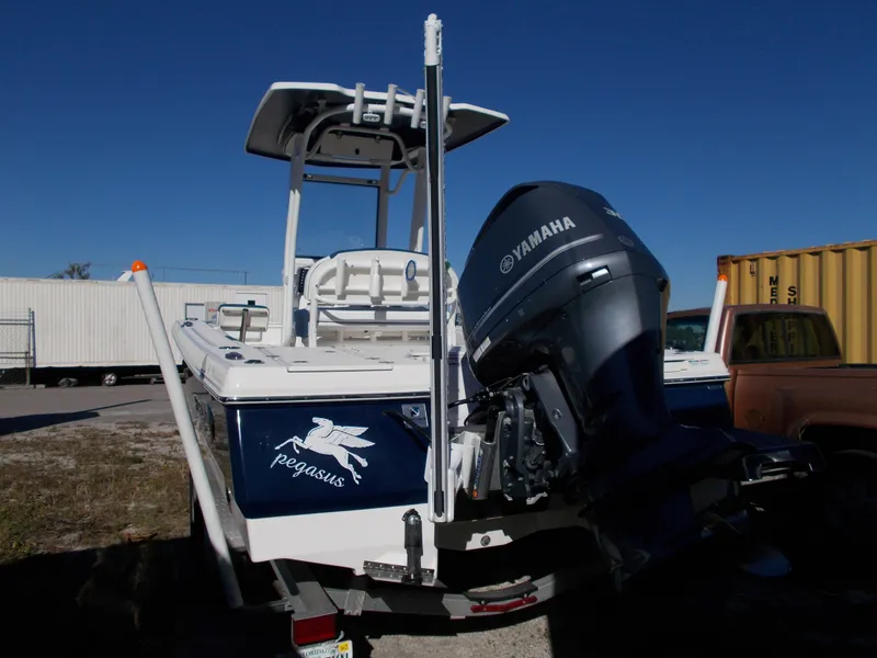 Slide: The Image of 2020 Robalo 246 Cayman boat with Yamaha engine, parked outdoors. - 3