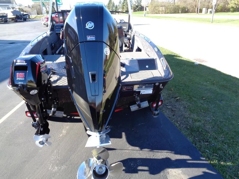 Slide: The Image of 2025 Vexus DVX22S boat with powerful outboard motor, parked on pavement. - 15