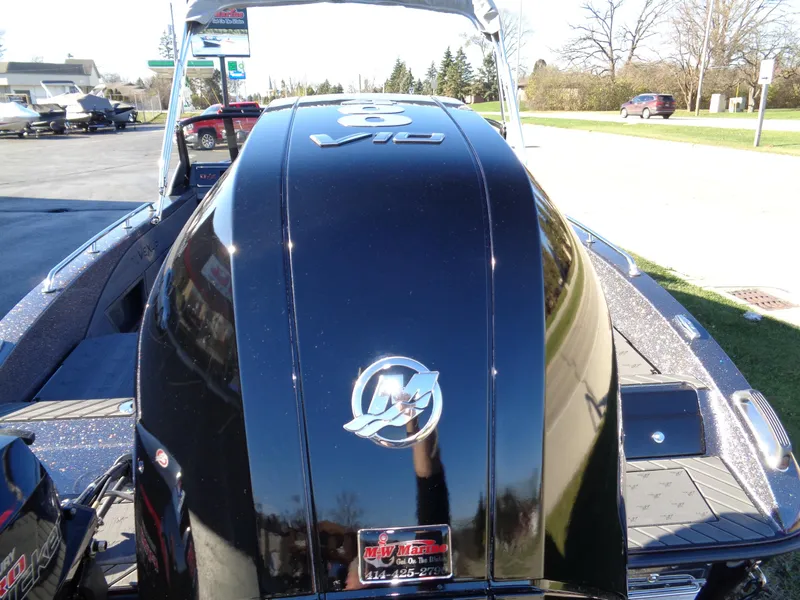 Slide: The Image of 2025 Vexus DVX22S boat with sleek black engine cover in outdoor setting. - 16