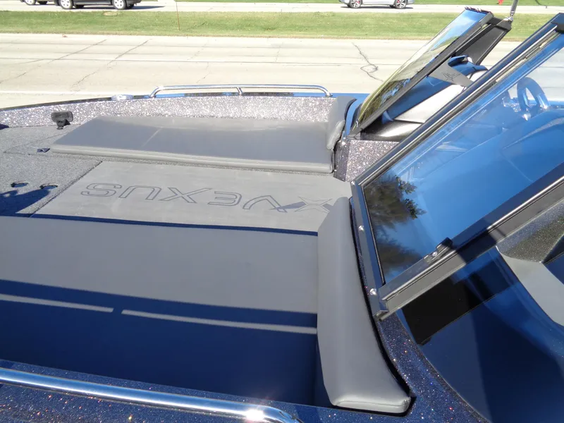 Slide: The Image of 2025 Vexus DVX22S boat with sleek design and windshield detail. - 25