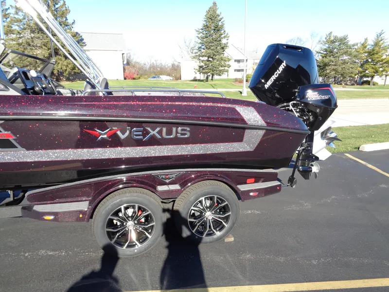Slide: The Image of 2025 Vexus DVX22S boat with Mercury engine on a trailer in a parking lot. - 3
