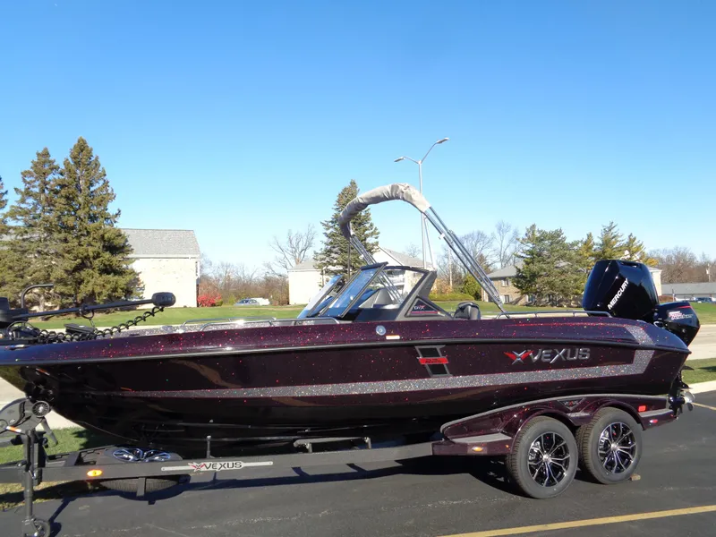 Slide: The Image of 2025 Vexus DVX22S boat on trailer, parked outdoors under clear blue sky. - 4
