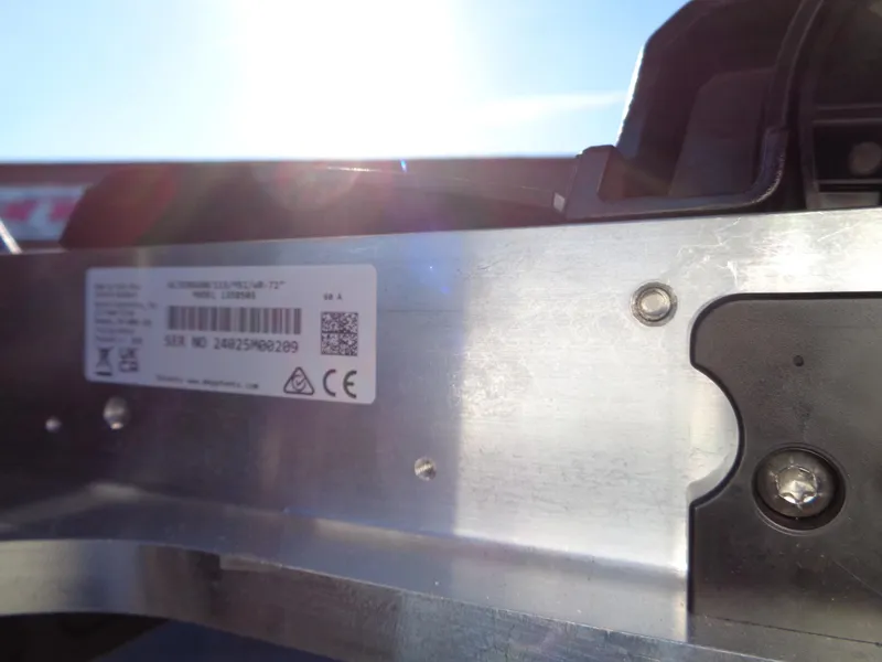 Slide: The Image of Close-up of a 2025 Vexus DVX22S metal component with a label and sunlight glare. - 9