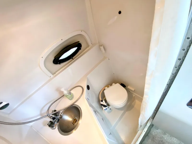 Slide: The Image of 1999 Four Winns 258 Vista boat bathroom with sink and toilet. - 20