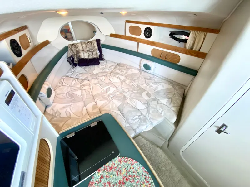 Slide: The Image of Interior cabin of 1999 Four Winns 258 Vista boat with cozy bedding and modern amenities. - 24