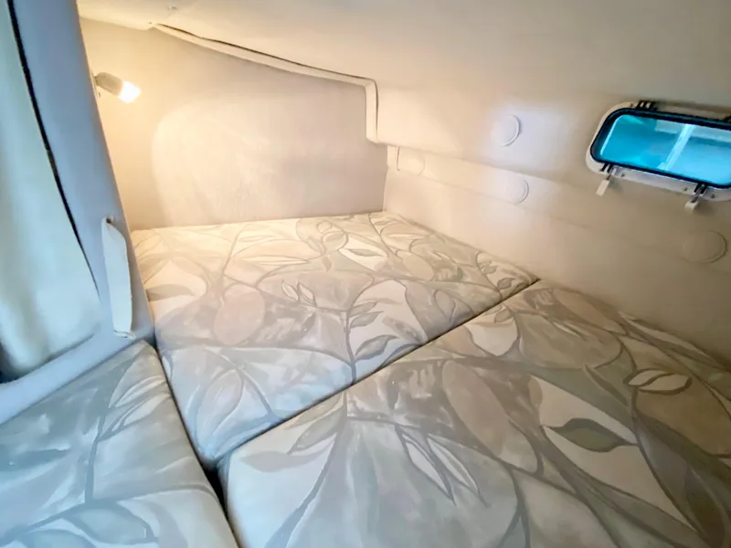 Slide: The Image of Cozy cabin interior of 1999 Four Winns 258 Vista boat with floral-patterned bedding. - 29