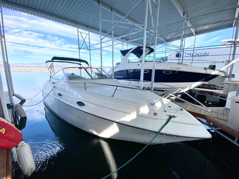 The Image of 1999 Four Winns 258 Vista boat docked under a covered marina. - 3